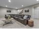 Spacious basement featuring a comfortable leather sectional, coffee table, and staircase leading to the upper floor at 2798 W High Grove Cir, Zionsville, IN 46077