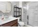 Bathroom featuring a vanity with dark wood cabinets, a modern sink, and a glass-enclosed shower at 2798 W High Grove Cir, Zionsville, IN 46077