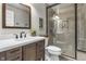 Bathroom featuring a vanity with dark wood cabinets, granite countertops, sink, toilet, and glass-enclosed shower at 2798 W High Grove Cir, Zionsville, IN 46077
