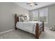 Bedroom with a wooden-framed bed, soft bedding, and natural light from the windows overlooking the landscape at 2798 W High Grove Cir, Zionsville, IN 46077