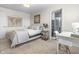 This well-lit bedroom offers a cozy setting, complete with a comfortable bed and a desk by the window at 2798 W High Grove Cir, Zionsville, IN 46077