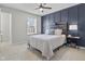 Bedroom with a modern accent wall, a cozy bed, and ample natural light from the window at 2798 W High Grove Cir, Zionsville, IN 46077