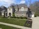 Beautiful brick and stone home with manicured front yard and convenient attached two-car garage at 2798 W High Grove Cir, Zionsville, IN 46077