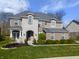 Charming two-story home with a stone facade, well-manicured lawn, and beautiful landscaping at 2798 W High Grove Cir, Zionsville, IN 46077