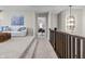 Hallway featuring neutral colors and decorative lighting leading to a bedroom with stylish furniture at 2798 W High Grove Cir, Zionsville, IN 46077