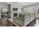 Bright living room with fireplace, TV, plush couch, hardwood floors, large windows, and elegant light fixture at 2798 W High Grove Cir, Zionsville, IN 46077
