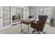 Bright office space with a wooden desk and leather chair, with easy access to other rooms at 2798 W High Grove Cir, Zionsville, IN 46077