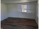 A cozy bedroom featuring sleek wood floors and a bright window at 2801 Brouse Ave, Indianapolis, IN 46218