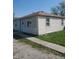 Simple, single-story home features light siding, a concrete walkway, and a functional design at 2801 Brouse Ave, Indianapolis, IN 46218