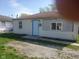 Modest single-story home with light siding and a simple, functional design under a sunny sky at 2801 Brouse Ave, Indianapolis, IN 46218