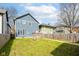 Backyard featuring lawn, wooden fence, wood deck, and multiple homes in view at 2945 N New Jersey St, Indianapolis, IN 46205