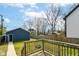 Backyard featuring a wood deck, lawn, wooden fence and blue siding on a home at 2945 N New Jersey St, Indianapolis, IN 46205