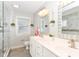 Modern bathroom featuring double sinks, tiled floors, and a walk-in shower at 2945 N New Jersey St, Indianapolis, IN 46205
