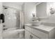Stylish bathroom with marble tiled shower, modern vanity, and elegant lighting fixtures at 3133 Ruckle St, Indianapolis, IN 46205