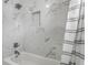 Bright bathroom showcasing a bathtub with marble tile surround and modern shower head at 3133 Ruckle St, Indianapolis, IN 46205