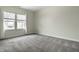 An airy bedroom with neutral walls, plush carpet, and two windows providing ample natural light at 3133 Ruckle St, Indianapolis, IN 46205