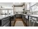 Open kitchen featuring gray cabinets, modern appliances, and a large basin sink at 3133 Ruckle St, Indianapolis, IN 46205