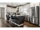 Modern kitchen with stainless steel appliances, a center island with seating, and white cabinetry at 3133 Ruckle St, Indianapolis, IN 46205