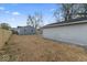 Image of spacious backyard with gray house and detached garage with fenced perimeter at 338 S Roena St, Indianapolis, IN 46241