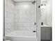 Modern bathroom featuring a shower and tub combination with large, stylish tiles and updated fixtures at 338 S Roena St, Indianapolis, IN 46241
