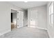 Bright bedroom with neutral carpet, showcasing multiple doorways and windows for ample light at 338 S Roena St, Indianapolis, IN 46241
