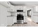 Beautiful kitchen with white cabinets, stainless steel appliances, and updated countertops at 338 S Roena St, Indianapolis, IN 46241