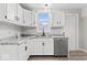 Modern kitchen featuring white cabinets, updated countertops, and stainless steel appliances at 338 S Roena St, Indianapolis, IN 46241