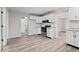 Bright kitchen boasts updated countertops and modern appliances, flowing seamlessly into an adjacent dining area at 338 S Roena St, Indianapolis, IN 46241