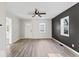 Bright, newly remodeled living room featuring gray walls, new floors, and a ceiling fan at 338 S Roena St, Indianapolis, IN 46241