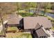 A high aerial view of the home's roof with an enclosed patio overlooking a pond and fencing at 3718 S County Road 101 E, Clayton, IN 46118