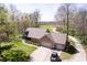 Aerial view of a brick home featuring a three car garage, expansive yard, and a private driveway at 3718 S County Road 101 E, Clayton, IN 46118