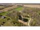 Aerial view of property featuring a pond and barn with surrounding fields and trees in the landscape at 3718 S County Road 101 E, Clayton, IN 46118