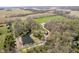 Scenic aerial view of land featuring a pond, outbuildings, and surrounding greenery and trees at 3718 S County Road 101 E, Clayton, IN 46118