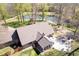 Aerial view of brick home with pond, patio and outbuildings on land with mature trees at 3718 S County Road 101 E, Clayton, IN 46118