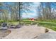 Outdoor entertaining space on concrete pad with picnic table and Adirondack chairs at 3718 S County Road 101 E, Clayton, IN 46118