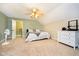 Bright bedroom with a ceiling fan, carpeted floors, and access to an ensuite bathroom at 3718 S County Road 101 E, Clayton, IN 46118