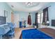 Spacious bedroom with a ceiling fan, a comfortable bed, a stylish decor and natural lighting at 3718 S County Road 101 E, Clayton, IN 46118