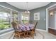 Charming breakfast nook featuring a wooden table, chandelier lighting, and views of the private backyard at 3718 S County Road 101 E, Clayton, IN 46118