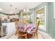 Cozy breakfast nook with a wooden table, bright windows, and backyard view in a well-lit space at 3718 S County Road 101 E, Clayton, IN 46118