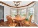 Charming dining room featuring hardwood floors, a bay window with sheer curtains, and views of the yard at 3718 S County Road 101 E, Clayton, IN 46118