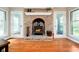 Close-up of a brick fireplace with a wood-burning stove, flanked by windows at 3718 S County Road 101 E, Clayton, IN 46118