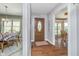 Inviting foyer with hardwood floors, decorative front door, and views of the dining room at 3718 S County Road 101 E, Clayton, IN 46118