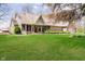 Beautiful brick home featuring a lush green lawn, complemented by mature trees and tasteful landscaping at 3718 S County Road 101 E, Clayton, IN 46118