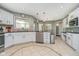 Well-lit kitchen with white cabinets, tile floors, and stainless steel appliances, ready for cooking at 3718 S County Road 101 E, Clayton, IN 46118