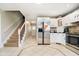 Kitchen with stainless steel refrigerator, white cabinets and a tile backsplash at 3718 S County Road 101 E, Clayton, IN 46118