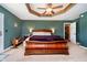 Comfortable main bedroom showcasing a tray ceiling, providing a relaxing retreat within the home at 3718 S County Road 101 E, Clayton, IN 46118