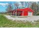 Exterior shot of bright red outbuilding featuring American flag and covered porch at 3718 S County Road 101 E, Clayton, IN 46118