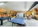 Large outbuilding interior space featuring ping pong, foosball, tractor, and couch at 3718 S County Road 101 E, Clayton, IN 46118
