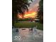 Stamped concrete patio area with Adirondack chairs positioned to enjoy the vibrant sunset sky at 3718 S County Road 101 E, Clayton, IN 46118