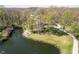 Aerial view of a serene pond surrounded by lush greenery and trees, enhancing the property's appeal at 3718 S County Road 101 E, Clayton, IN 46118